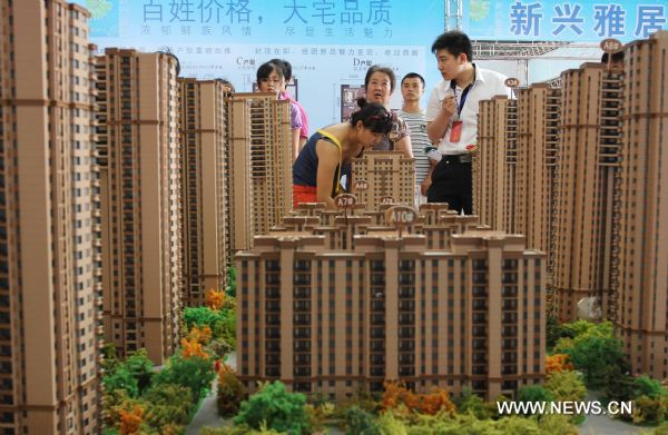 Photo taken on July 6, 2011, shows citizens visiting the Summer Real Estate Fair in Shenyang, capital of northeast China's Liaoning Province. © Xinhua