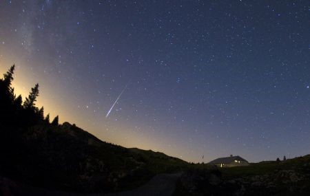 A meteor streaks past stars in the night sky at the Mont-Tendre near Montricher in the Jura, north of Geneva, late August 12, 2009. The Perseid meteor shower is sparked every August when the Earth passes through a stream of space debris left by Comet Swift-Tuttle. This picture was taken using a long exposure and a fisheye lens. ©Reuters