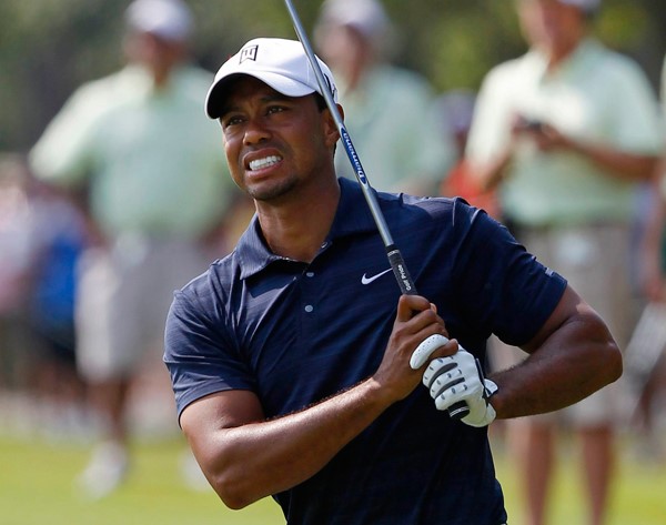 Tiger Woods of the U.S. reacts after hitting his second shot on the ninth hole during first round play of The Players Championship golf tournament at TPC Sawgrass in Ponte Vedra Beach, Florida May 12, 2011. Tiger Woods’ troubles continued as he withdrew from the Players Championship on Thursday through injury after slipping to six over par after the opening nine holes. © Reuters