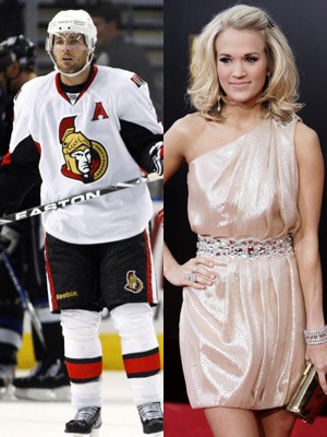 File photo shows country singer Carrie Underwood (R) and Ottawa Senators' Mike Fisher. ©Reuters